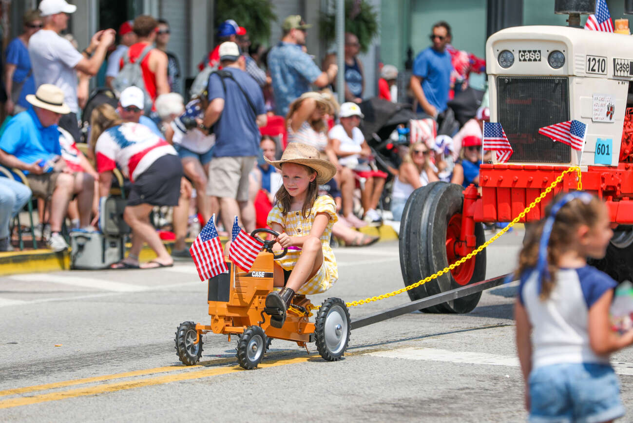 A string of tractors roll down Main Street in downtown Zelienople during Zelienople's Fourth of July parade on Friday, July 4, 2025. Morgan Phillips/Butler Eagle